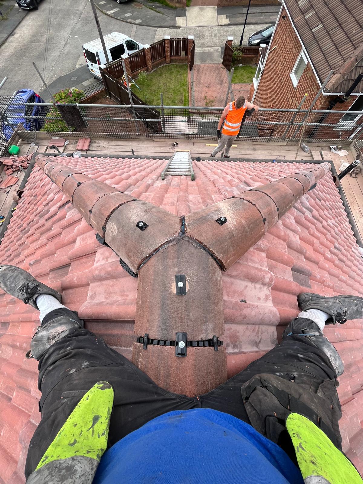 Ackroyd & Son Roofing — roofer fitting a new dry ridge system on a UK pitched roof